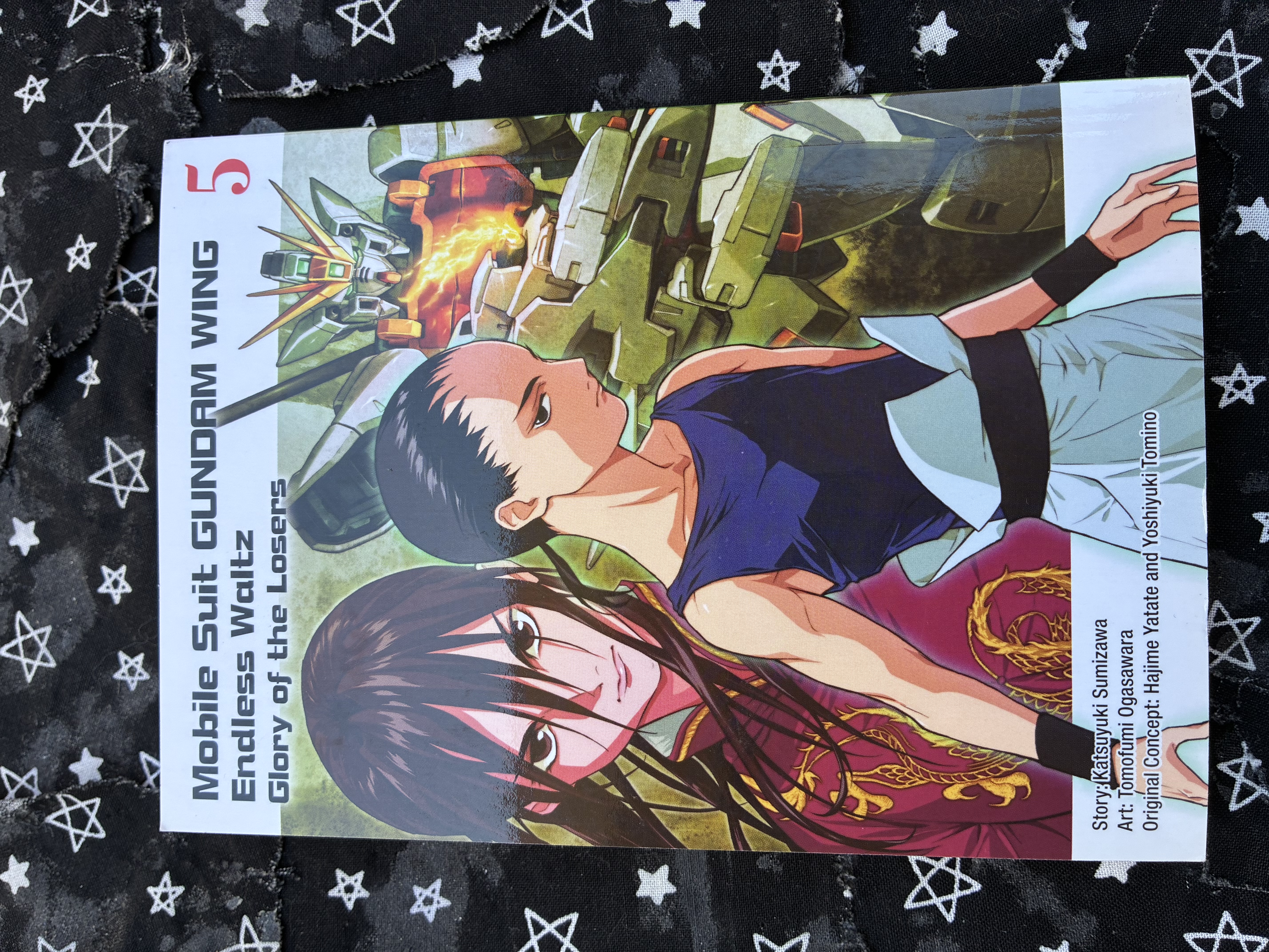 Front of volume 5 of the manga Mobile Suit Gundam Wing: Endless Waltz: Glory of the Losers with Wufei, Meilan, and Shenlong on the cover.